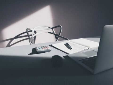 Laptop and calculator on a desk