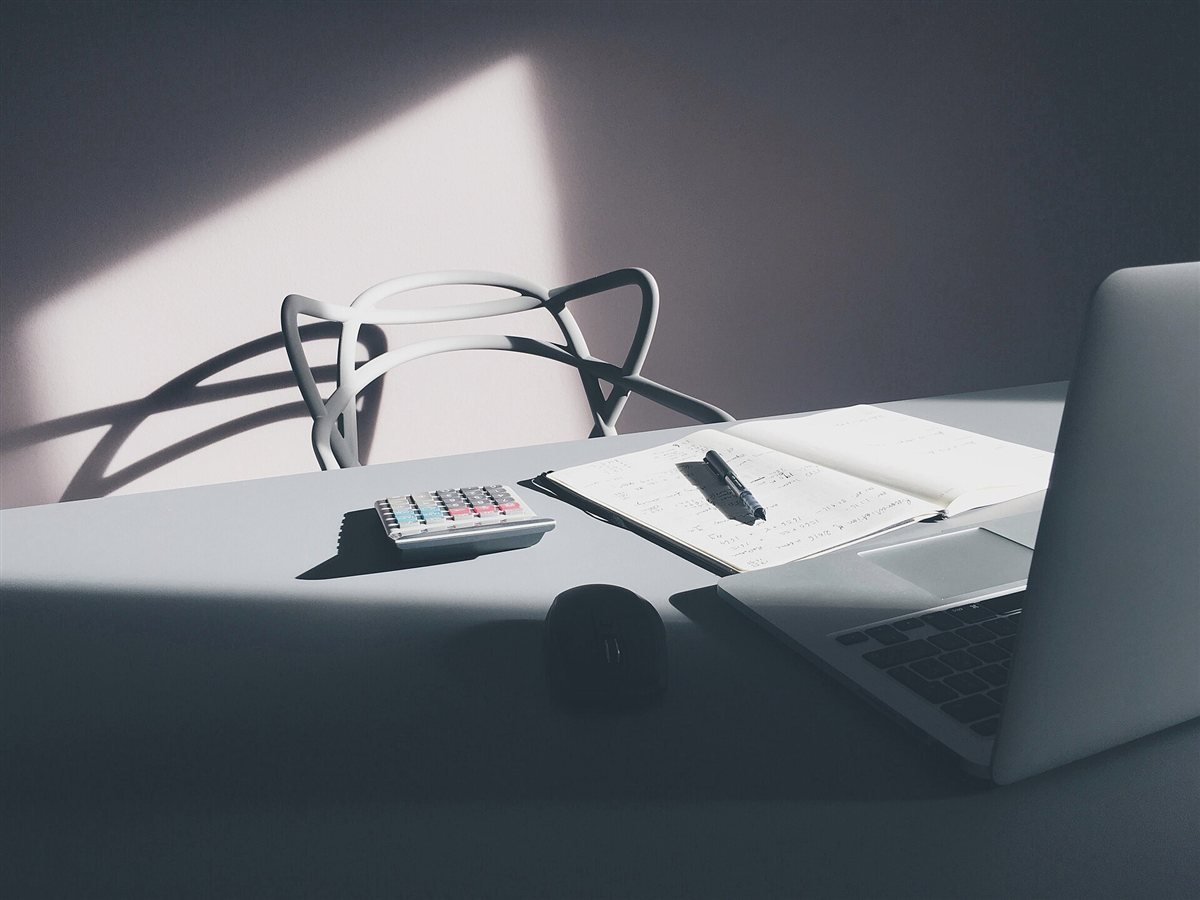 Laptop and calculator on a desk