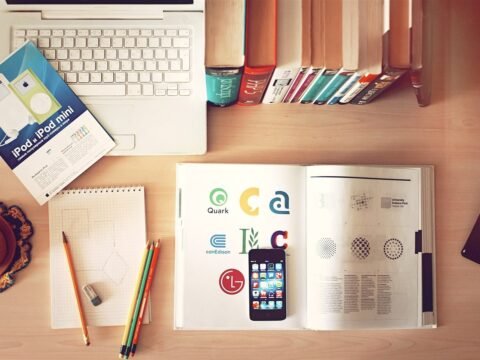 Books, pencils, laptop and phone on a desk