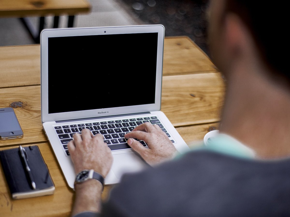 Person typing on a laptop at a desk